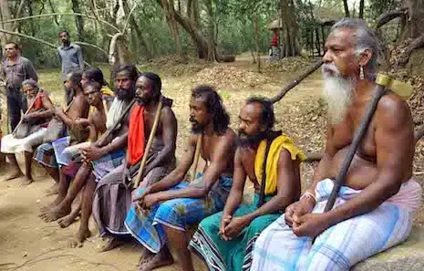 Vedda community elders seated together near Dambana, Sri Lanka, with their chief on the right