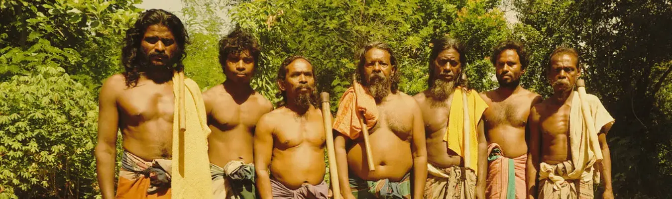 A group of Vedda men from the Dambana community standing together in the forest
