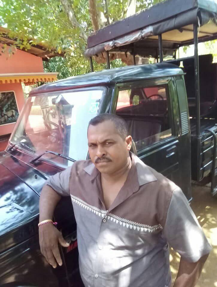 Bandara standing beside his safari jeep in Wasgamuwa